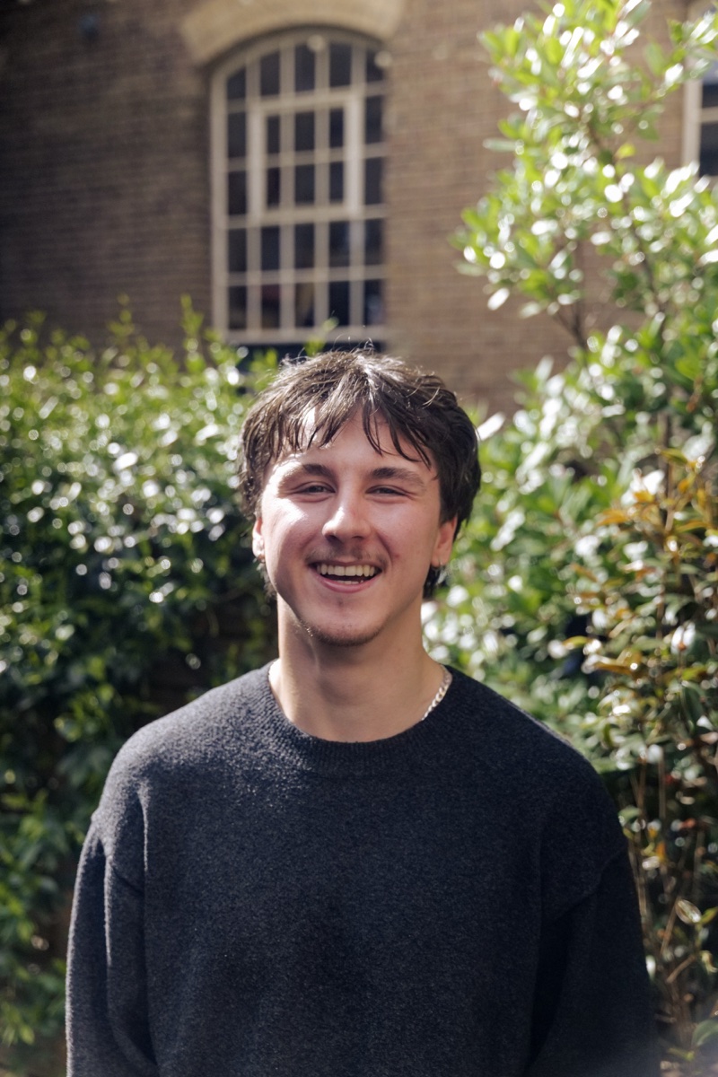 Sasha, freelance website creator, smiling outdoors